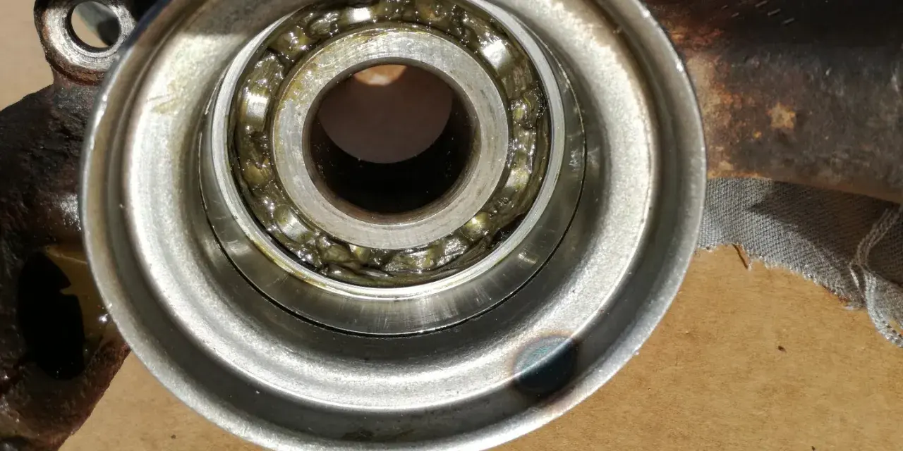 Close-up of a car wheel bearing with grease.