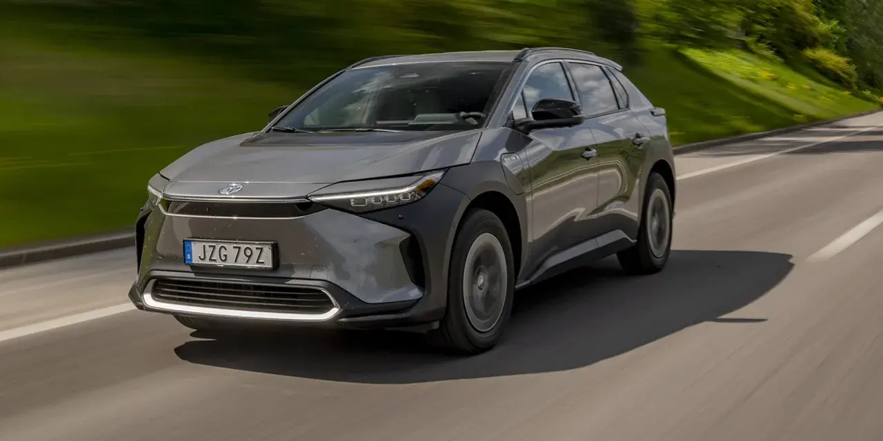 Grå Toyota bZ4X kör på en landsväg. Trots att det är en elbil, finns det ett känt toyota bz4x problem med hjulen.
