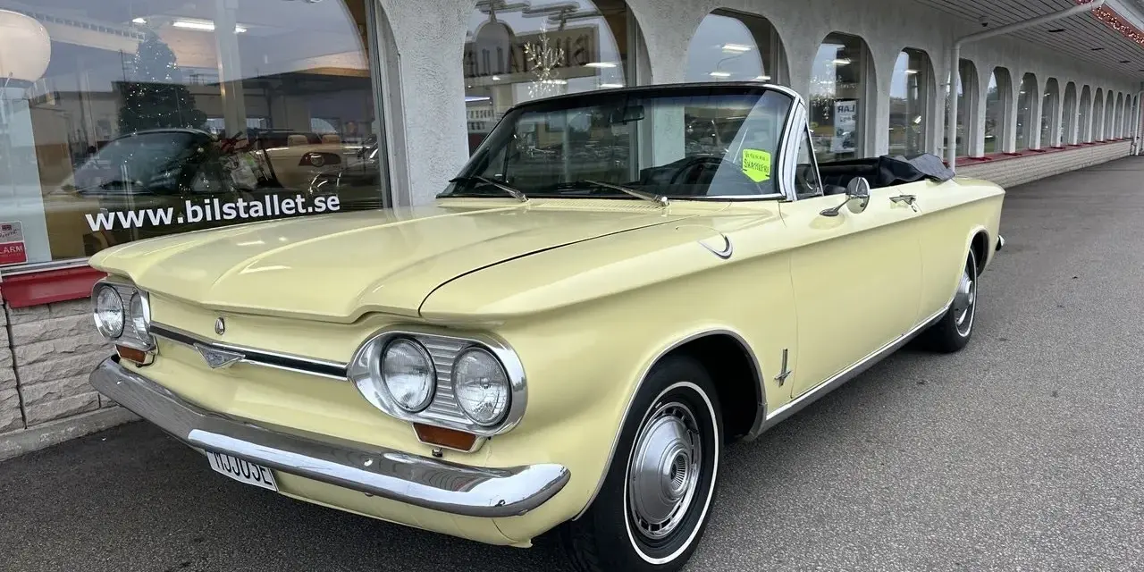 Gul cabriolet Chevrolet Corvair från 1960-talet parkerad utanför Bilstallet.