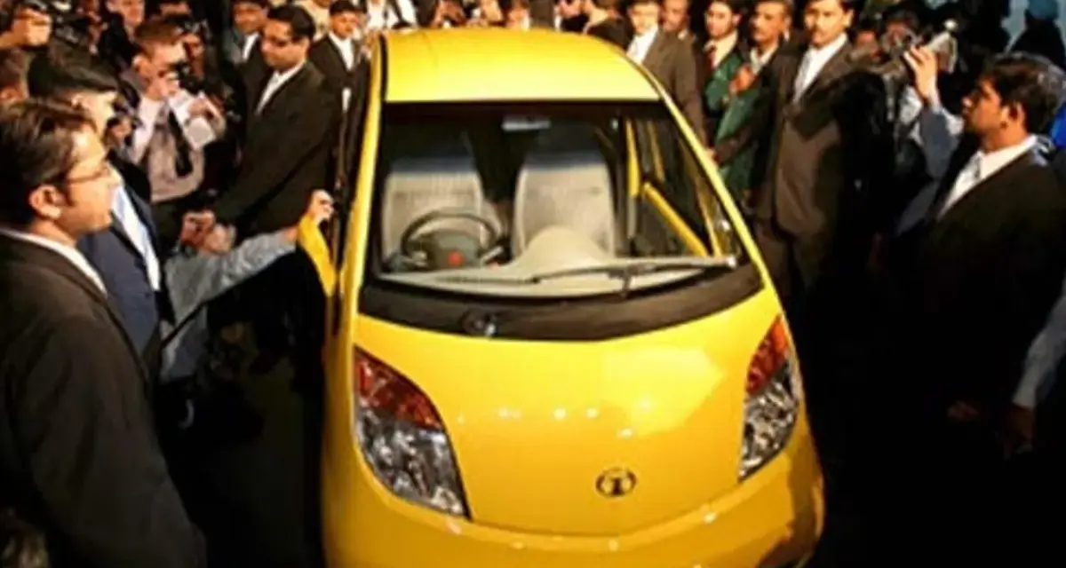 En gul Tata Nano visas upp för en folkmassa.