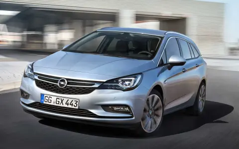 Silver Opel Astra kombi körs på en väg. En bra bil för familjen, perfekt för ett opel astra begagnad test.