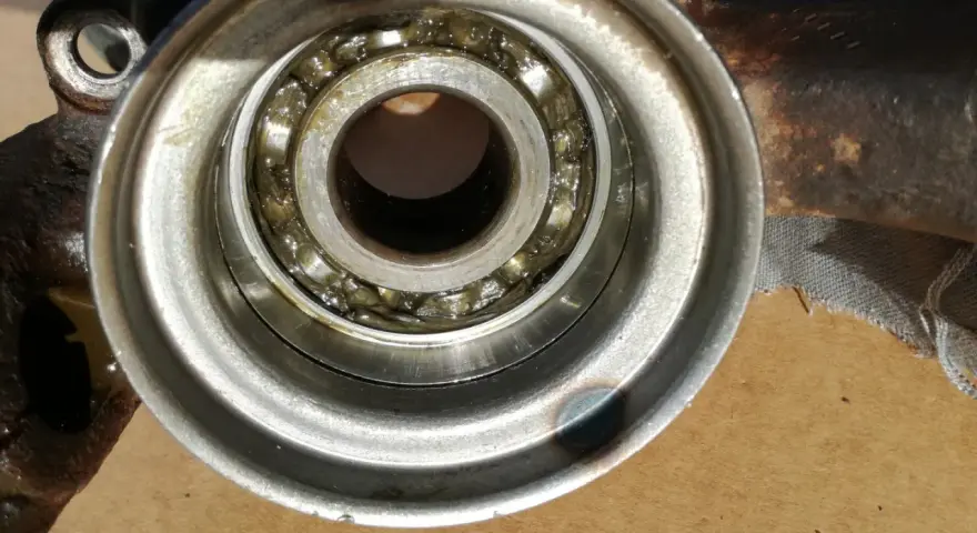 Close-up of a car wheel bearing with grease.