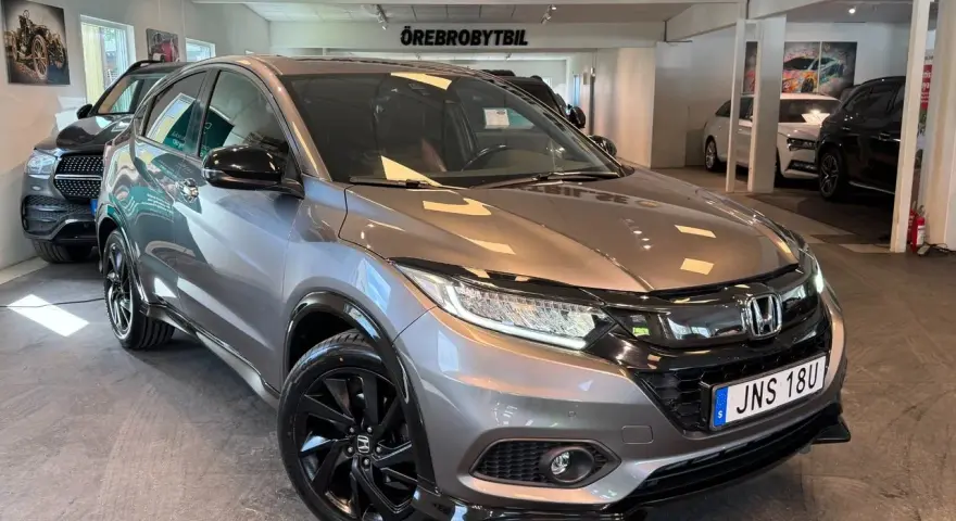 Grå Honda HR-V med svarta fälgar. Inga synliga problem med denna bil, bara en snygg SUV.